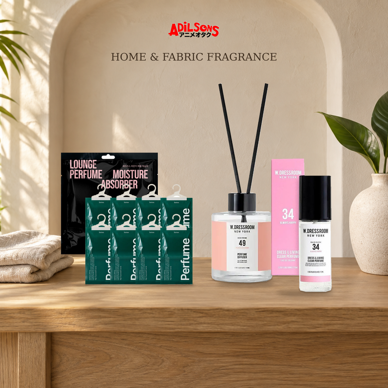 Adilsons Fragrance — Home & Fabric Fragrance: Diffuser, Fabric Spray, Moisture Absorber displayed in a warm, faceless fragrance setting.