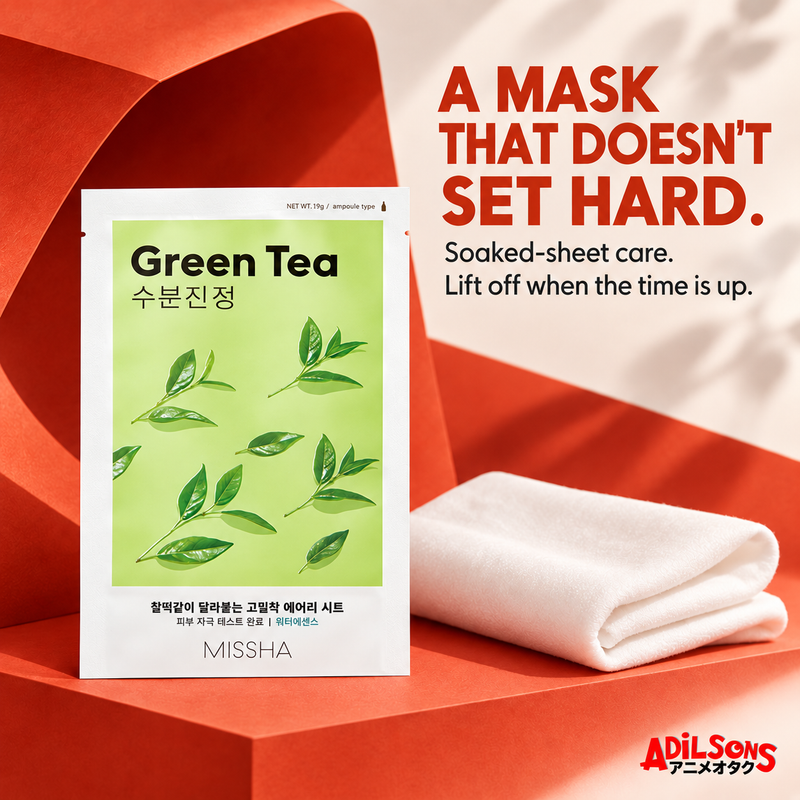 MISSHA Green Tea mask on a bold red sculptural set beside folded soft fabric.