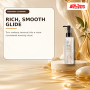 Rich cleansing oil in a soft pearl-and-amber sensorial still life.